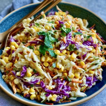 Fresh crunchy corn slaw made with sweet corn, shredded cabbage, colorful peppers, and a creamy tangy dressing.