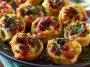 Crispy tortellini party snacks served with dipping sauce on a platter.