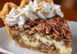 Creamy pecan pie with a smooth filling and crunchy toasted pecans on top.