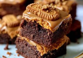 Fudgy Biscoff brownies with swirls of cookie butter on top, cut into squares with a rich, gooey center.
