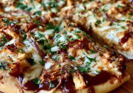 BBQ chicken pizza topped with grilled chicken, red onions, melted cheese, and tangy barbecue sauce on a crispy crust.