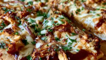 BBQ chicken pizza topped with grilled chicken, red onions, melted cheese, and tangy barbecue sauce on a crispy crust.