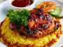 Honey BBQ chicken served over fluffy rice, glazed with a sweet and smoky sauce and garnished with green onions and sesame seeds.