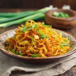 Spicy potato noodles stir-fried with chili sauce and vegetables