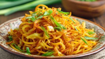 Spicy potato noodles stir-fried with chili sauce and vegetables
