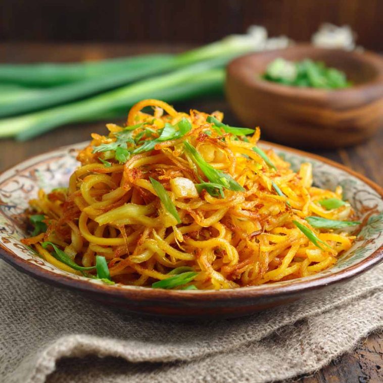 Spicy potato noodles stir-fried with chili sauce and vegetables