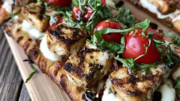 Chicken Caprese flatbread topped with mozzarella, tomatoes, basil, and balsamic glaze.