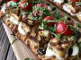 Chicken Caprese flatbread topped with mozzarella, tomatoes, basil, and balsamic glaze.