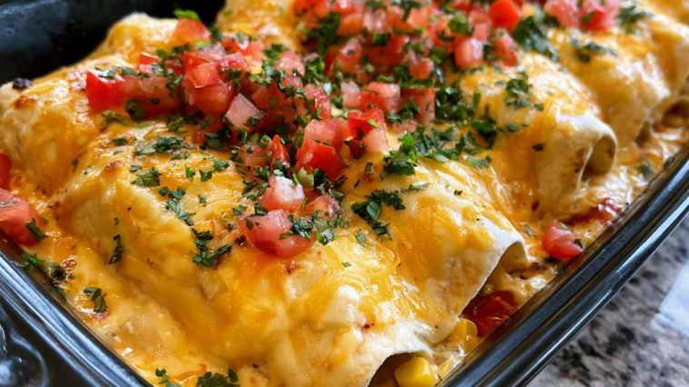 Chicken enchiladas covered in creamy queso sauce, cheesy and baked.