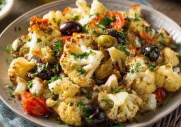 Marinated cauliflower salad with fresh vegetables and Mediterranean herbs.