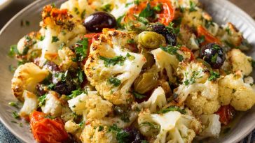 Marinated cauliflower salad with fresh vegetables and Mediterranean herbs.