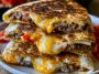 Crispy smashburger quesadillas filled with seasoned ground beef, melted cheese, and sauce, toasted until golden and sliced into wedges.
