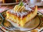 Light lemon custard cake dusted with powdered sugar, featuring soft cake layers and a creamy lemon custard center.