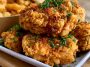 Crispy breaded chicken topped with melted cheese and ham, golden and juicy.
