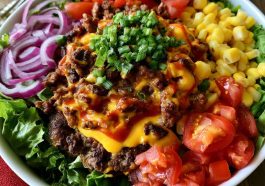 Smash burger bowl with ground beef, lettuce, cheese, pickles, and burger sauce.