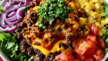 Smash burger bowl with ground beef, lettuce, cheese, pickles, and burger sauce.