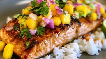 Salmon fillet glazed with mango teriyaki sauce served with rice and vegetables