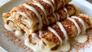 Thin crepes with cinnamon filling and protein-rich ingredients, soft and rolled.