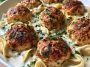 Chicken ricotta meatballs simmered in creamy Alfredo sauce served in a skillet