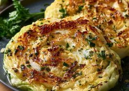 Garlic butter roasted cabbage steaks with crispy edges and golden color.