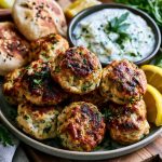Chicken kofta served with creamy garlic yogurt sauce and herbs.