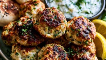 Chicken kofta served with creamy garlic yogurt sauce and herbs.