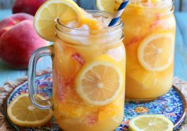 Refreshing beach peach lemonade with fresh peaches and lemon slices in a chilled glass with ice.