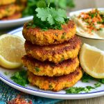 Golden coconut curry carrot and chickpea patties served crispy with herbs and a creamy dipping sauce.