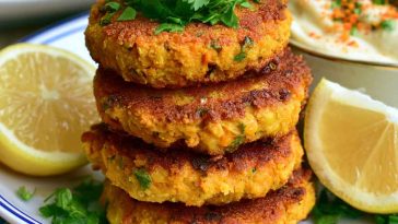 Golden coconut curry carrot and chickpea patties served crispy with herbs and a creamy dipping sauce.