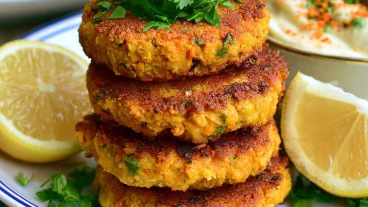 Golden coconut curry carrot and chickpea patties served crispy with herbs and a creamy dipping sauce.