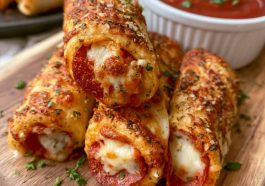Golden pepperoni pizza roll breadsticks filled with melted cheese and pepperoni, brushed with garlic butter and baked until crispy.