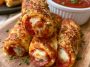 Golden pepperoni pizza roll breadsticks filled with melted cheese and pepperoni, brushed with garlic butter and baked until crispy.