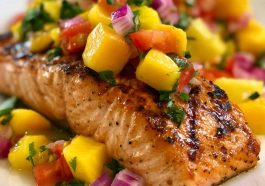 Grilled salmon topped with fresh mango salsa made with diced mango, red onion, cilantro, and lime.