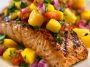 Grilled salmon topped with fresh mango salsa made with diced mango, red onion, cilantro, and lime.