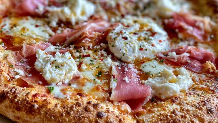 Gourmet prosciutto honey burrata pizza topped with creamy burrata cheese, thin prosciutto slices, fresh herbs, and a drizzle of honey.