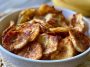 Crispy air fryer banana chips coated in cinnamon sugar, arranged in a bowl for a healthy homemade snack.