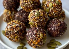 Chocolate bites topped with crunchy pumpkin seeds, rich and bite-sized.