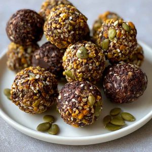 Chocolate bites topped with crunchy pumpkin seeds, rich and bite-sized.