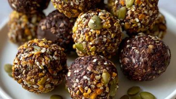 Chocolate bites topped with crunchy pumpkin seeds, rich and bite-sized.