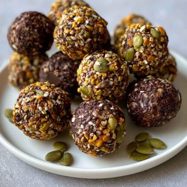 Chocolate bites topped with crunchy pumpkin seeds, rich and bite-sized.
