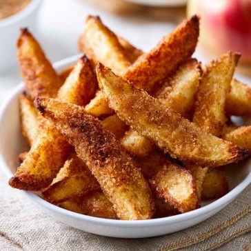 Crispy air fryer apple fries coated with cinnamon sugar and served warm.