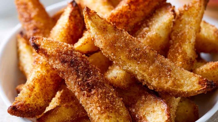 Crispy air fryer apple fries coated with cinnamon sugar and served warm.