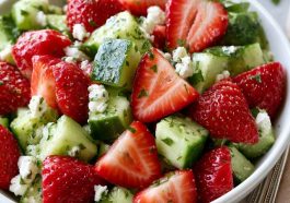 Fresh cucumber strawberry salad with sliced strawberries and cucumbers.