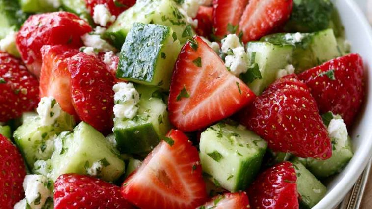 Fresh cucumber strawberry salad with sliced strawberries and cucumbers.