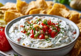 Creamy pickle de gallo ranch dip with chopped pickles and herbs.