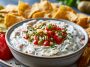 Creamy pickle de gallo ranch dip with chopped pickles and herbs.