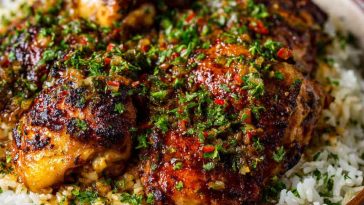 Brazilian galinhada with chicken and seasoned rice, hearty and colorful.
