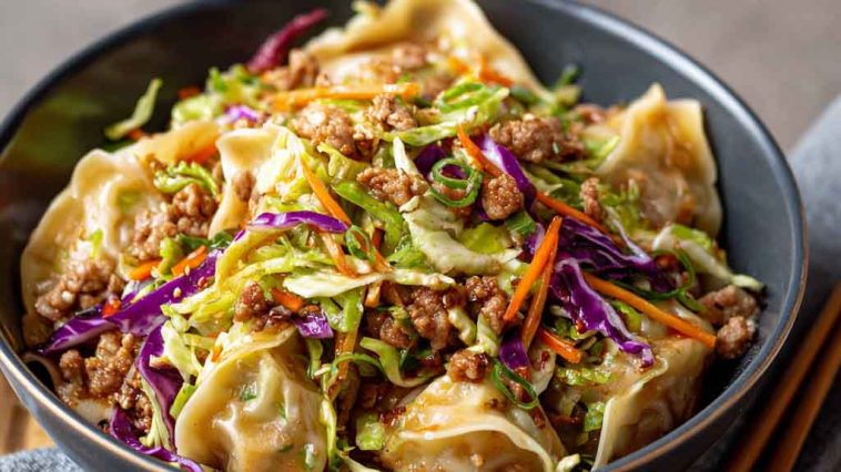Noodle bowl with savory pork, cabbage slaw, and potsticker-style sauce.