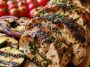 Mediterranean chicken marinade with olive oil, lemon, garlic, and herbs coating raw chicken in a bowl.