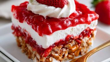 Layered strawberry pretzel salad with a crunchy pretzel crust, creamy cheesecake filling, and fresh strawberry gelatin topping.